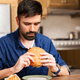 Image for article titled Man Inspects Perimeter To Find Most Vulnerable Entry Point To Hamburger